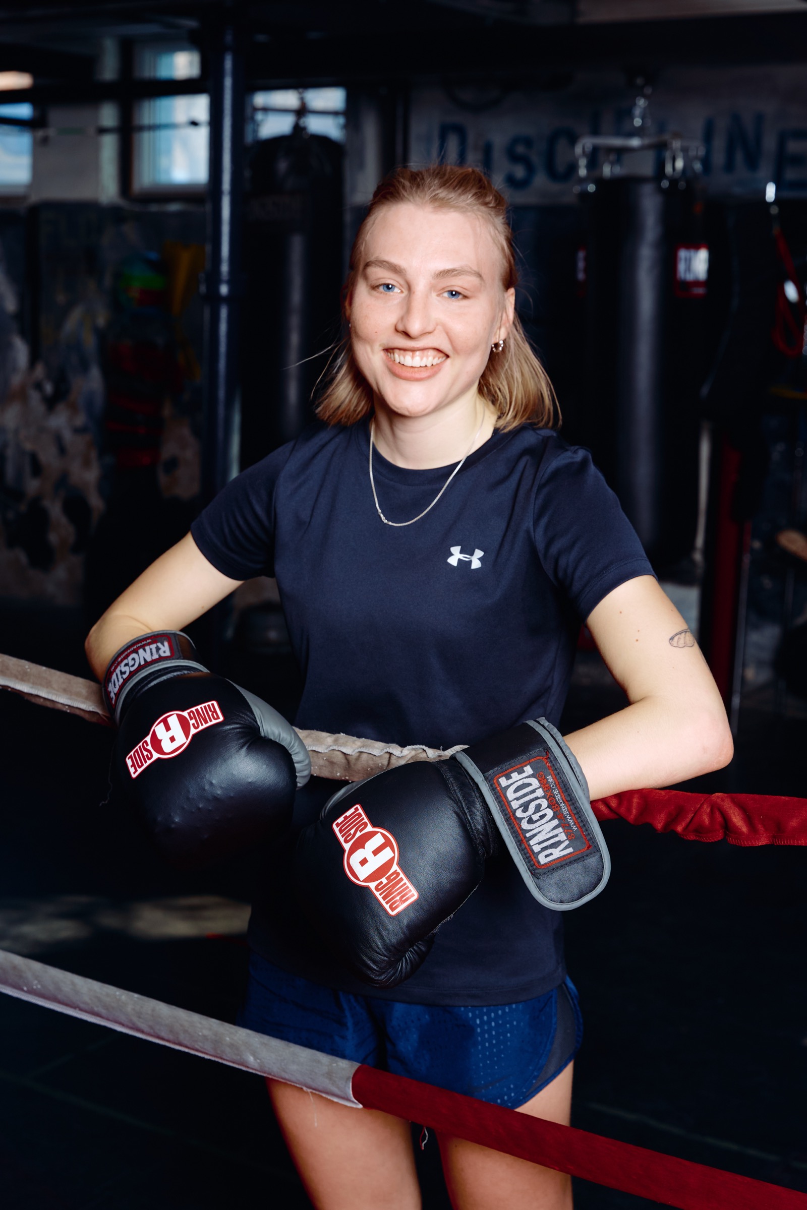 Woman smiling with boxing gloves